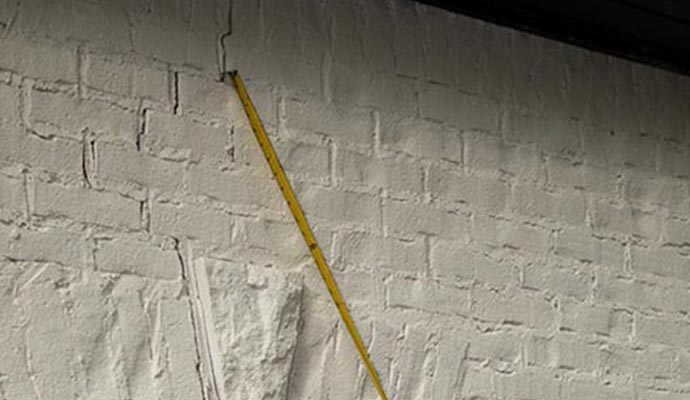bowed basement walls with visible cracks, indicating the need for repairs.