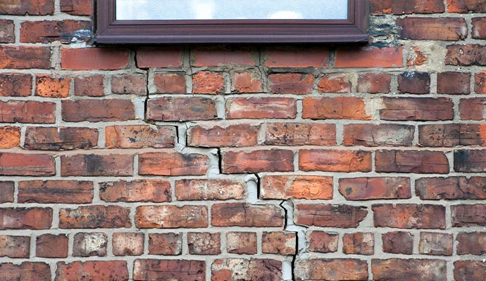 Stair step cracks near window